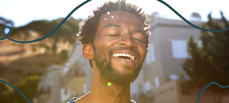 Black man with short hair smiles with his eyes closed